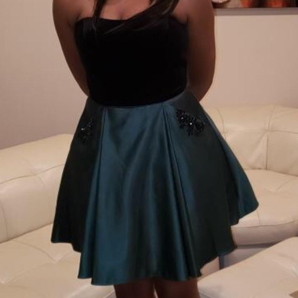 Strapless black velvet and emerald green dress.